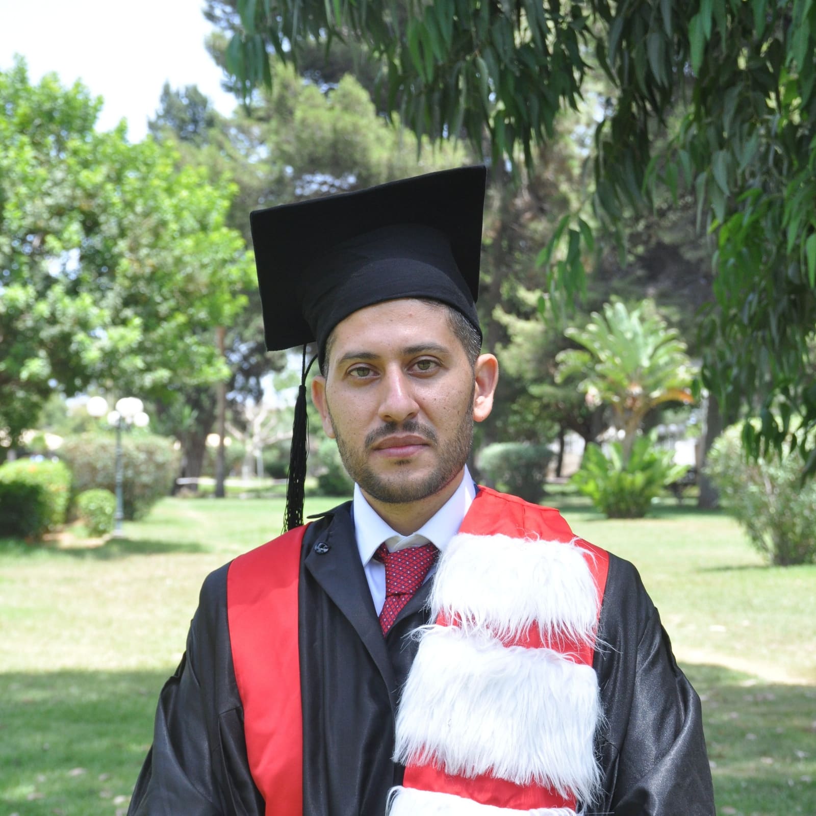 Dr. Badawi Abdalsalam in academic dress with his doctoral certificate